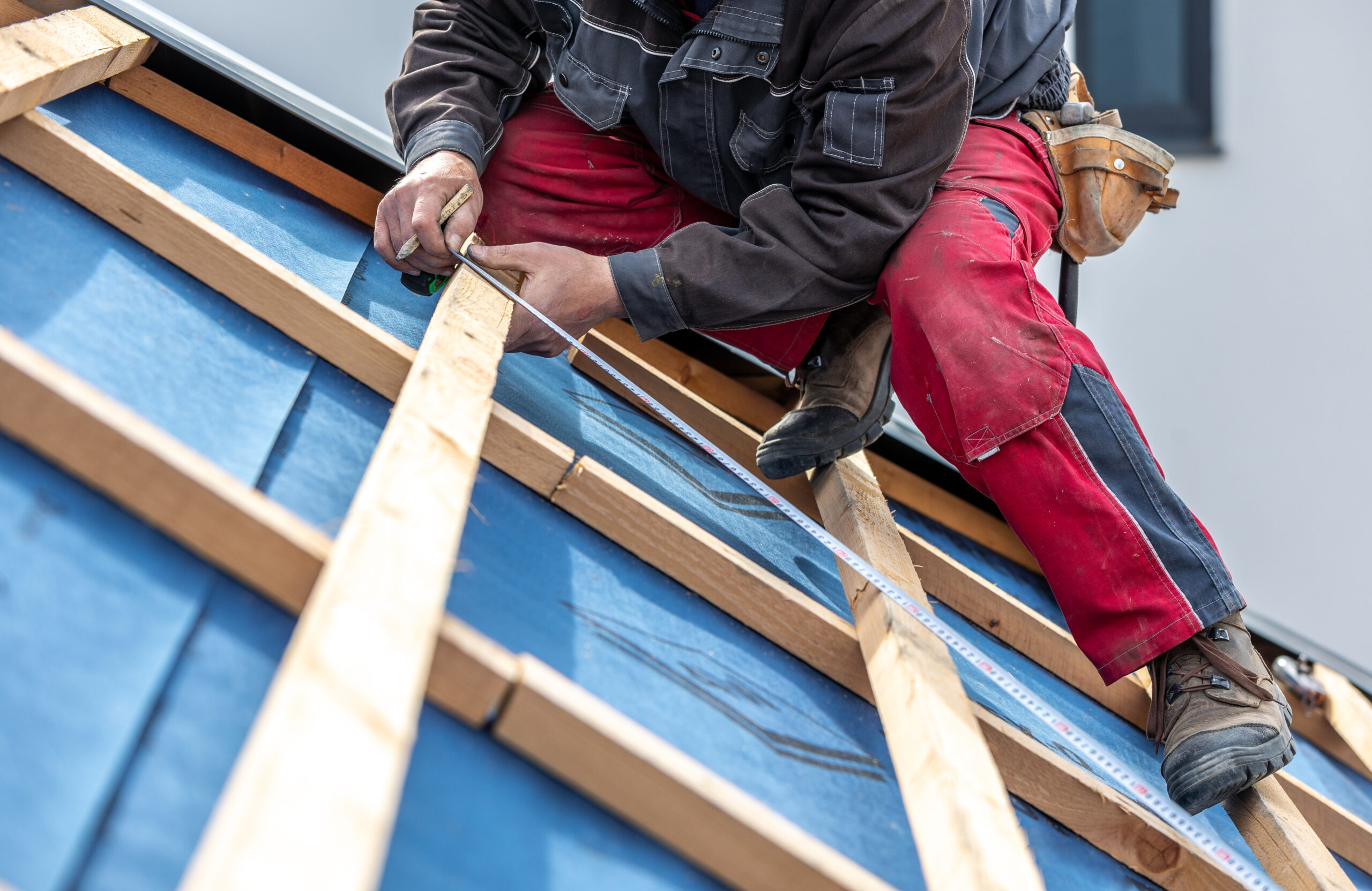 Craftsman or construction worker install new roof, roofing tools, new metallic roof or metal sheet, building concept